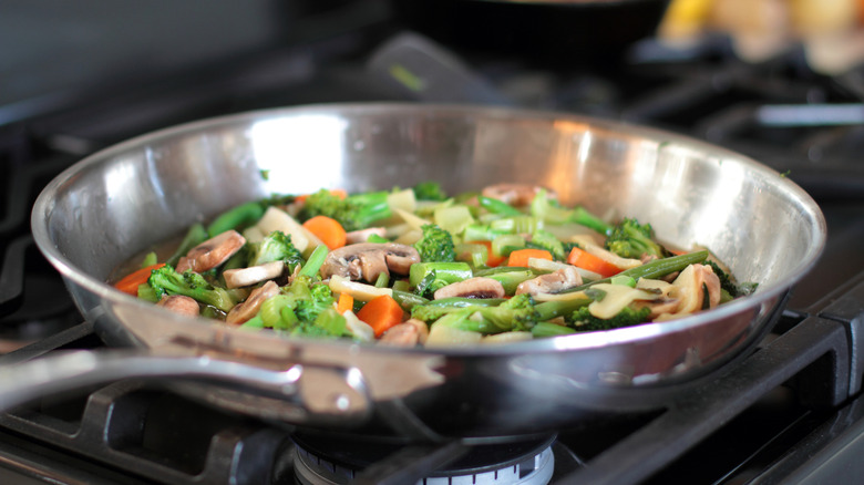 Stir fry vegetables in stainless steel pan