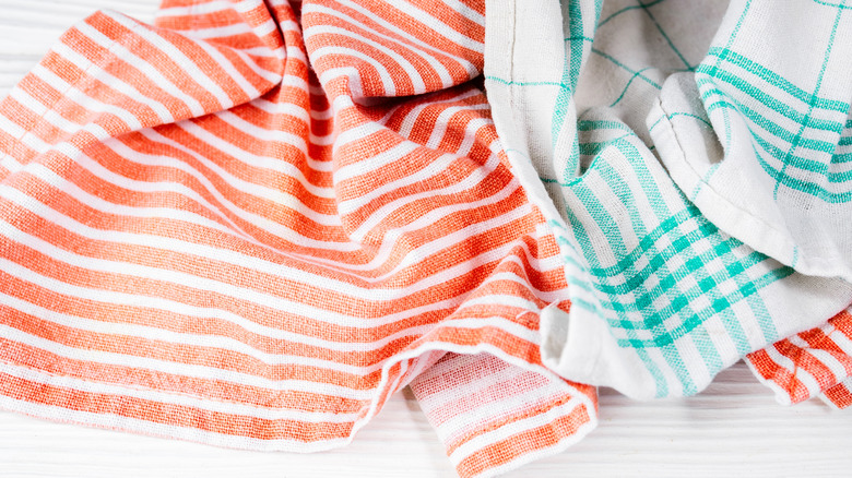 colorful kitchen towels on a white wooden table