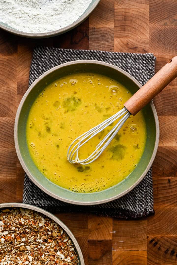 Whisking together eggs in a bowl.