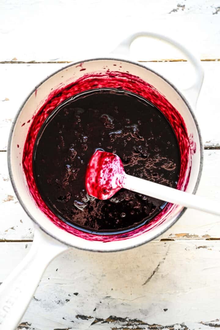 blueberry filling ingredients in white saucepan after cooking down.