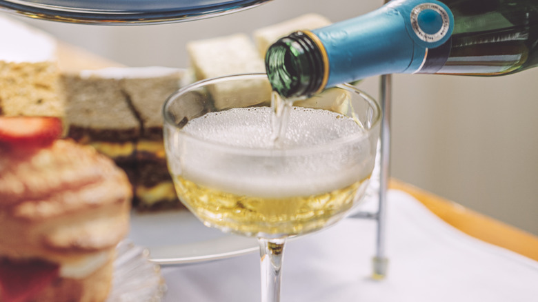 champagne pouring into a coup glass