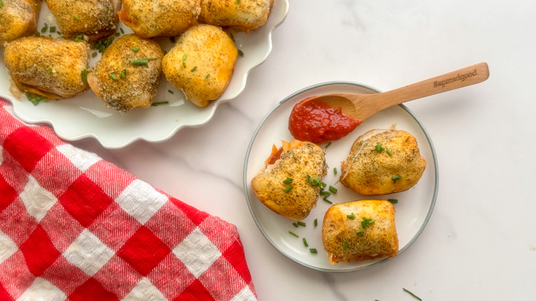 hand holding plate of bites