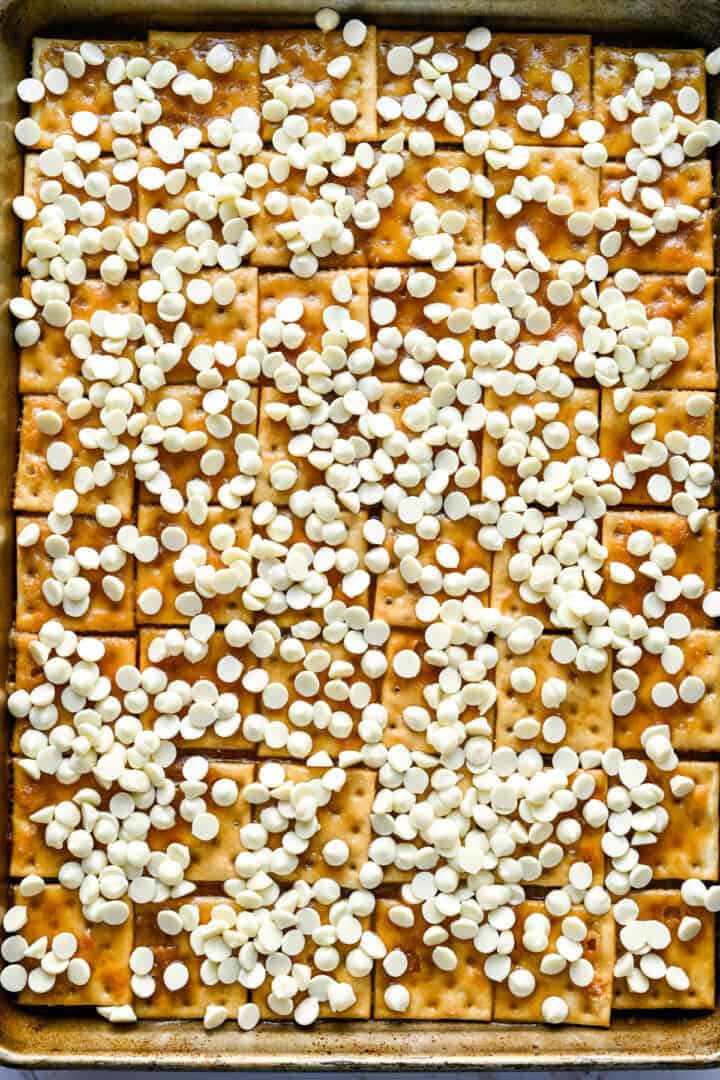 Overhead view of crack after sprinkling white chocolate chips on top.