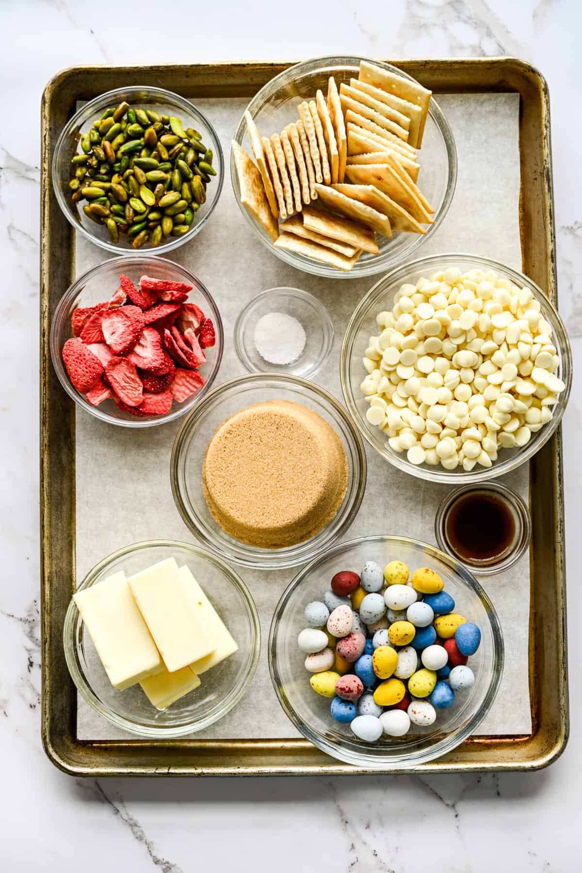 Overhead view of easter crack ingredients, including white chocolate chips, butter, and sugar.