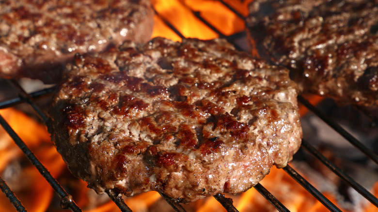 Meat patties cooking on a grill