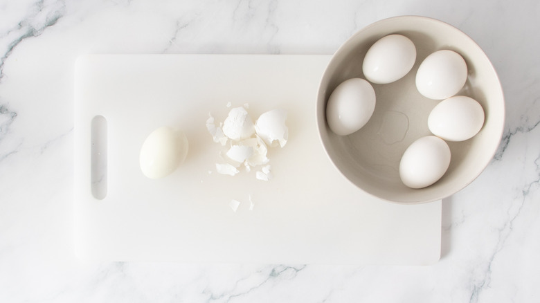 peeled egg on a cutting board