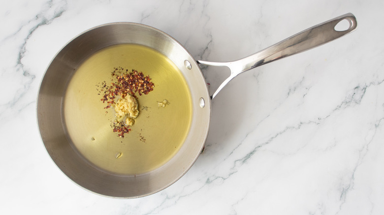 ginger and spices in pan with oil