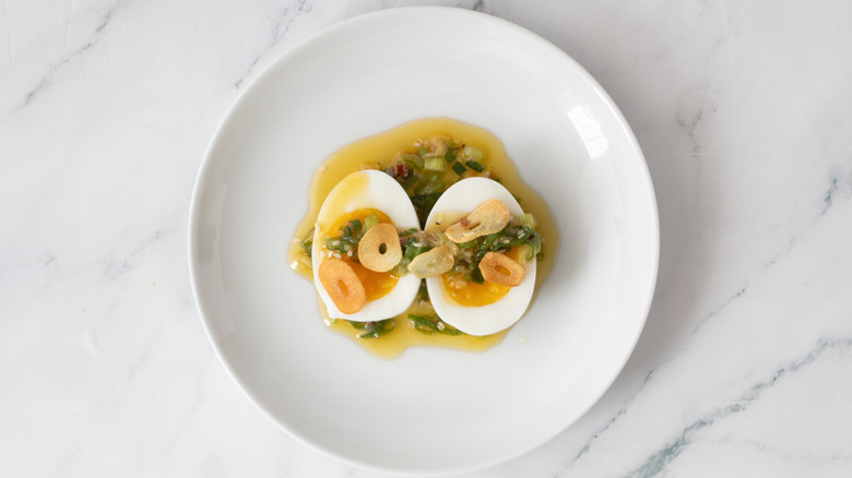 assembled jammy eggs with scallion drizzle