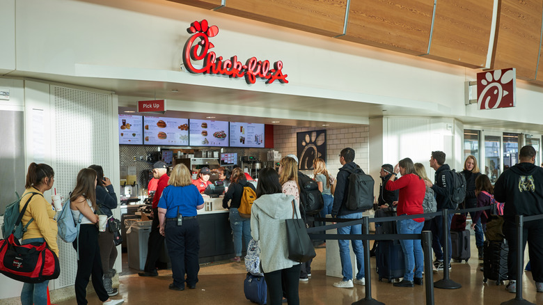 A busy Chick-fil-A with employees taking orders from customers at the counter