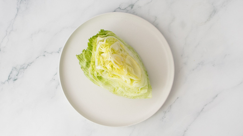 Wedge of iceberg lettuce on a plate