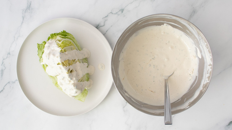 Wedge of iceberg lettuce topped with bleu cheese dressing