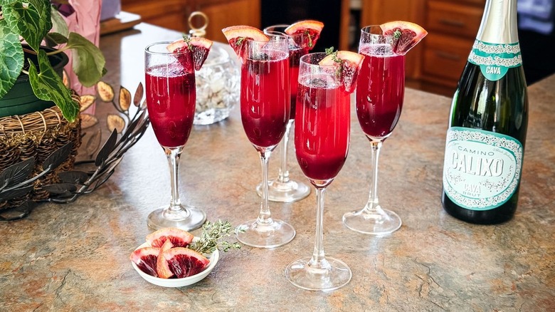 mixed berry blood orange mimosas on countertop