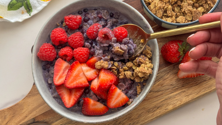 Bowl of blueberry oats topped with berries and streusel