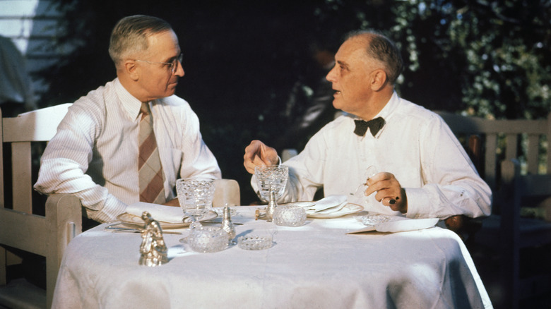 Senator Harry Truman, then the Democratic Vice-Presidential candidate, shares a meal with President Franklin D. Roosevelt outside at the White House.