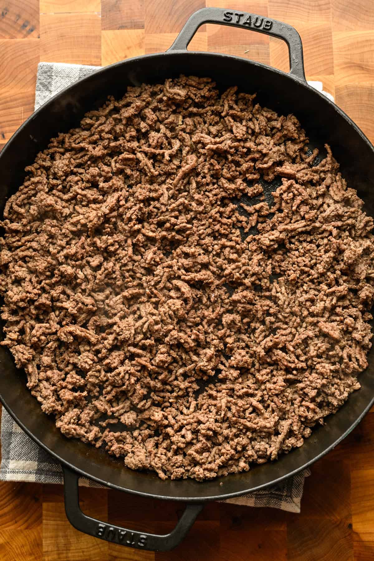 Ground beef cooked in a large skillet.