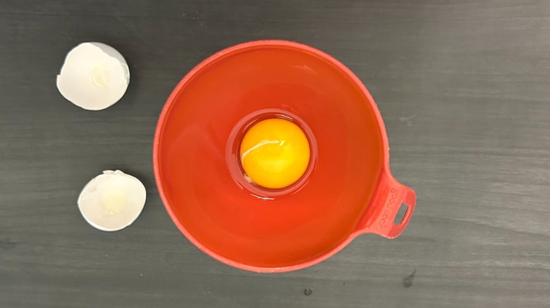 Egg cracked into a funnel