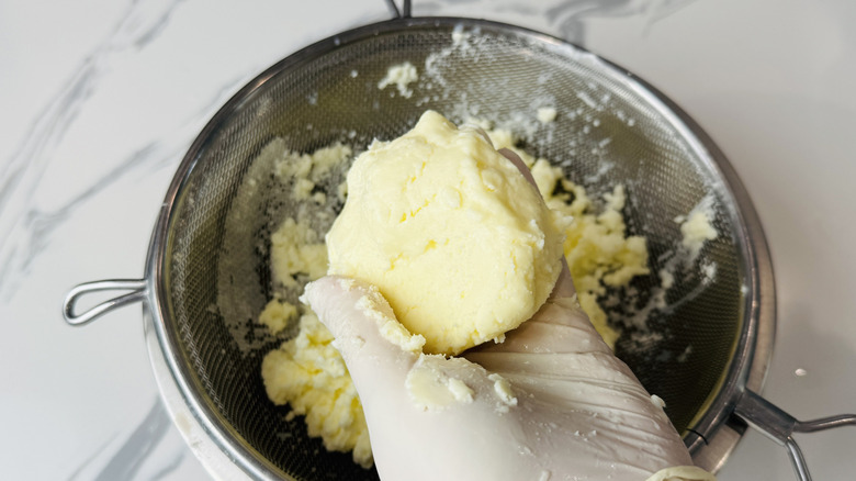 Squeezing homemade butter