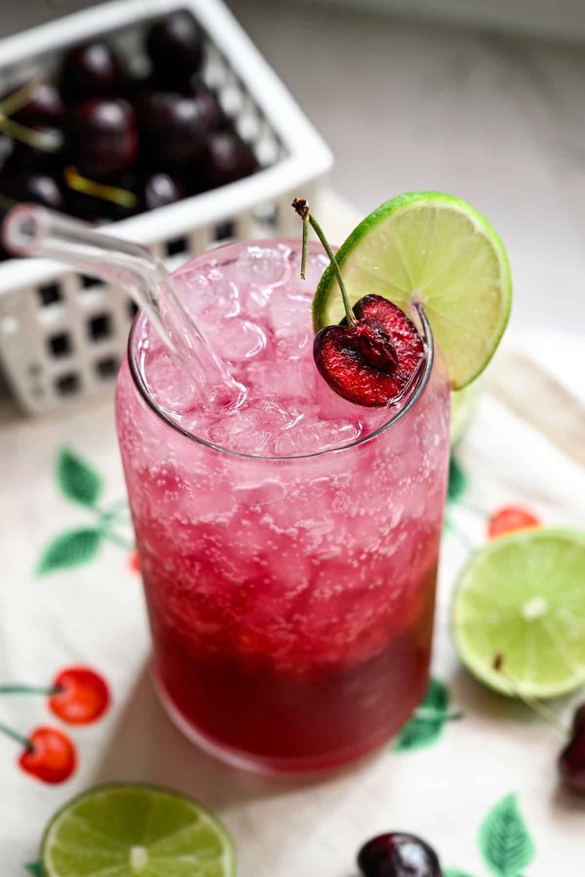 Overhead view of cherry lime soda in a glass with ice.