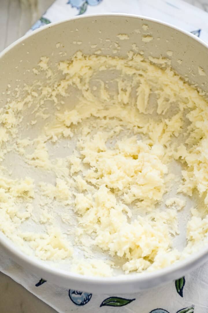 Butter and sugar creamed together in a bowl.