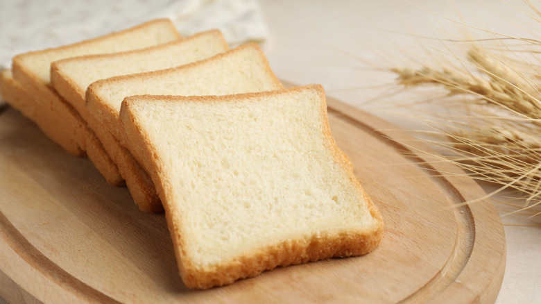 Slices of toast on a wooden board.