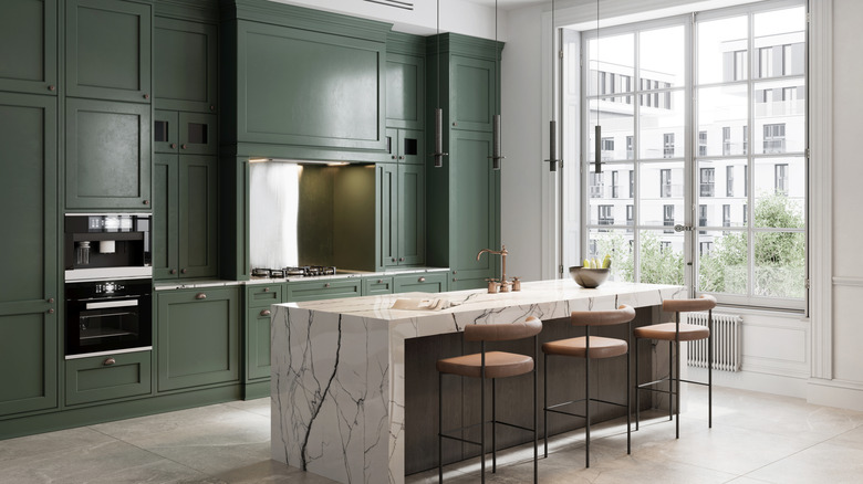 Modern kitchen with floor-to-ceiling dark green cabinets