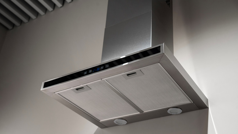 A stainless steel range hood seen from below.