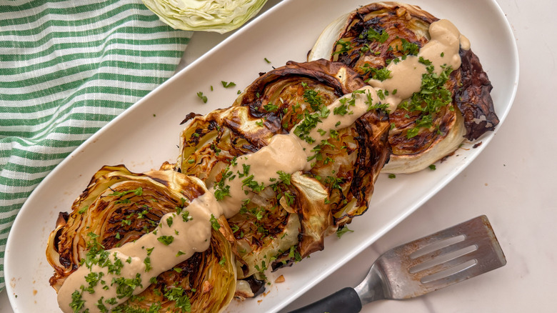 platter with cabbage steaks and tahini drizzle