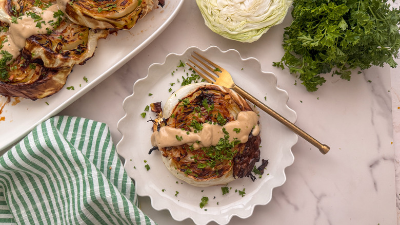 cabbage steak with tahini drizzle on plate