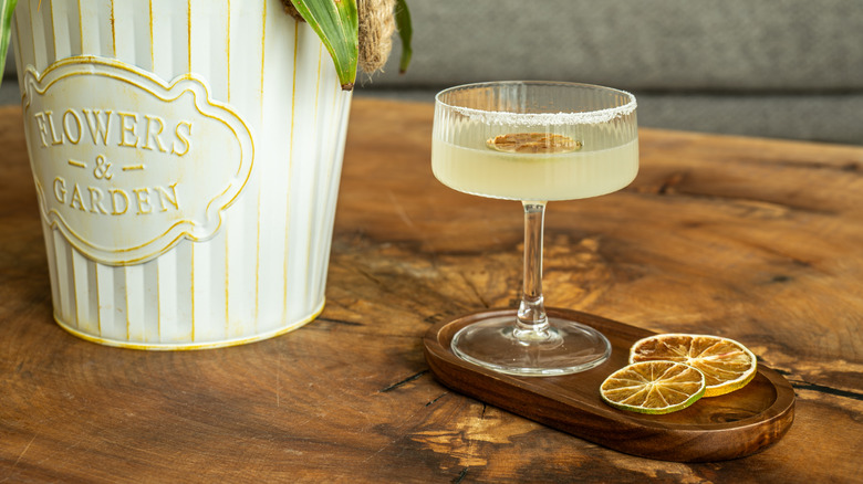 A frozen citrus margarita on a wooden table.