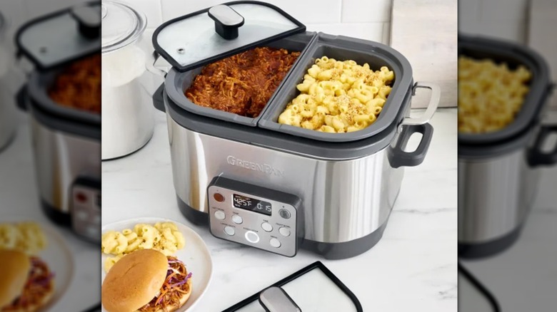 slow cooker with shredded pork on one side and macaroni on other