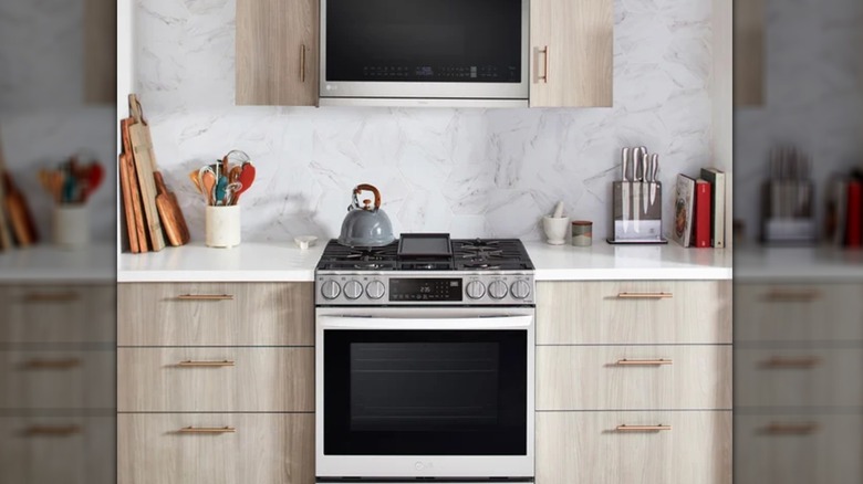 microwave oven over cooking range in modern kitchen