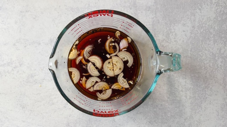 Sambal matah-ish brine in glass measuring cup