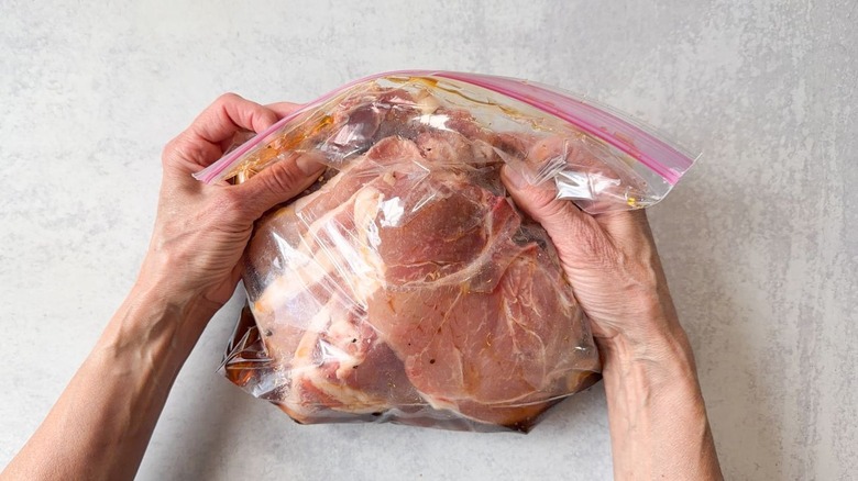 Pork chops and brine sealed in ziplock bag