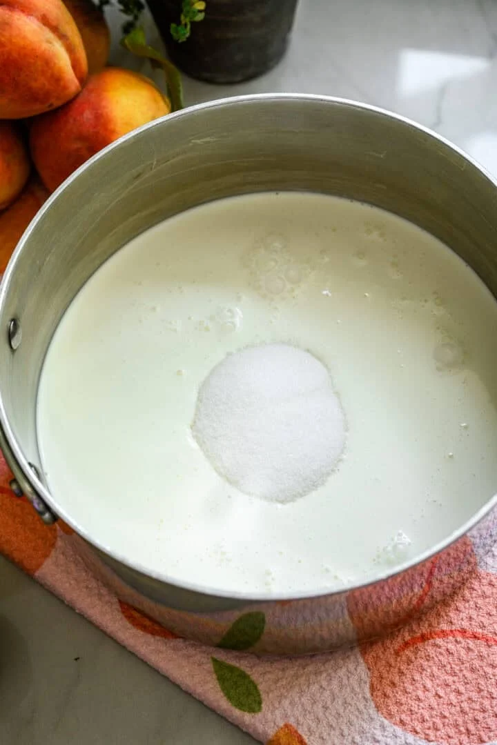 Heavy cream, milk, and sugar in a pot.