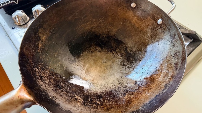 Peanut oil heating in wok on stovetop
