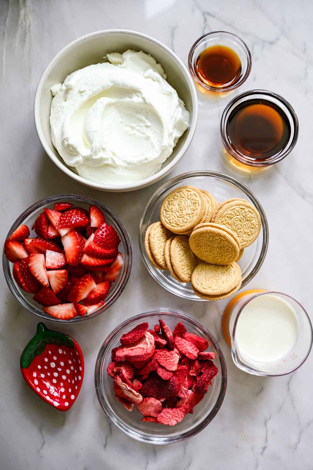 overhead view of ingredients for strawberry shortcake ice cream bars in small prep bowls. 