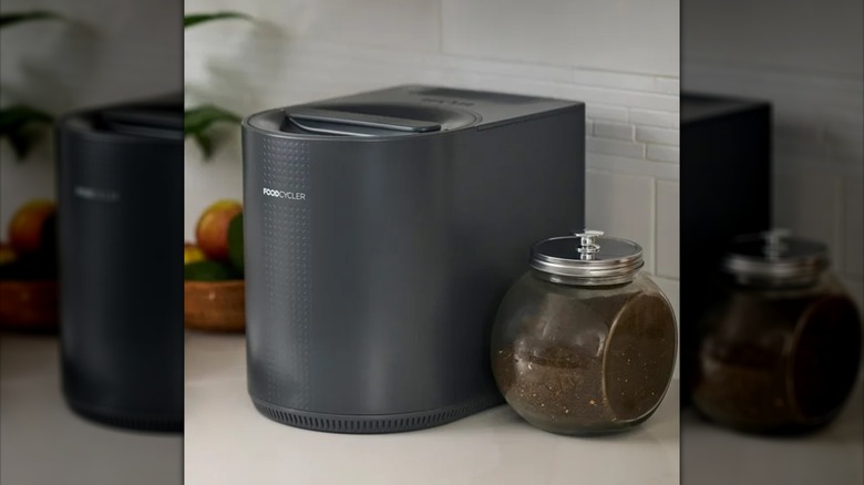 Countertop Electric Kitchen Food Recycler with a jar of ground coffee on the side