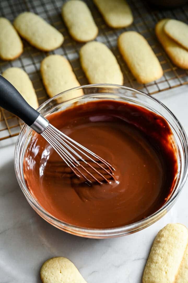 chocolate ganache in a mixing bowl with a whisk.