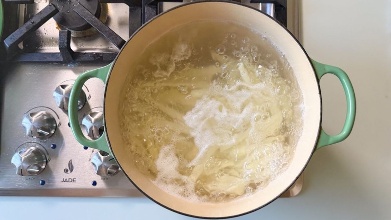 Pot of boiling water and potatoes on stovetop