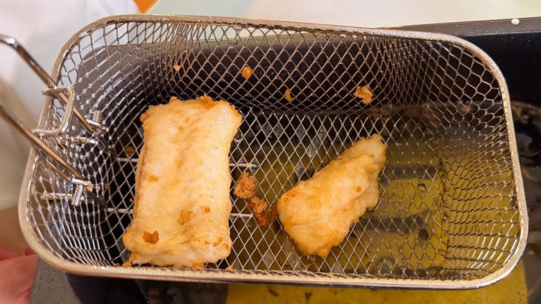 Battered cod filets in fryer basket
