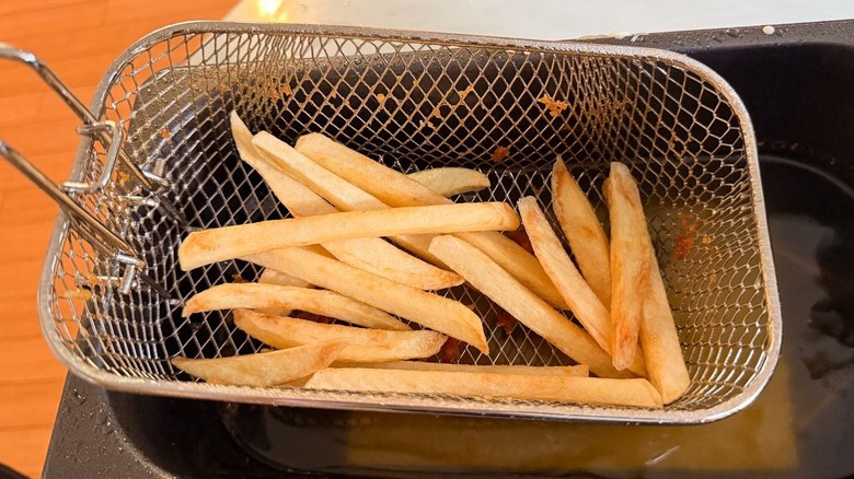 Golden brown chips in fryer basket