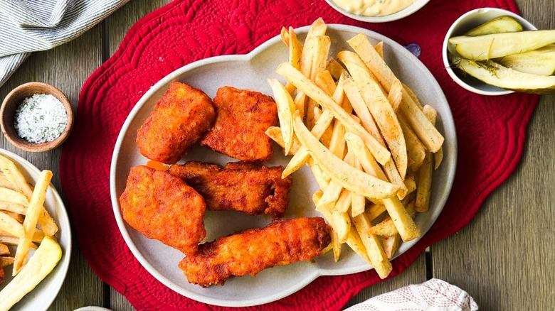 Nashville hot fish and chips on serving platter with pickles