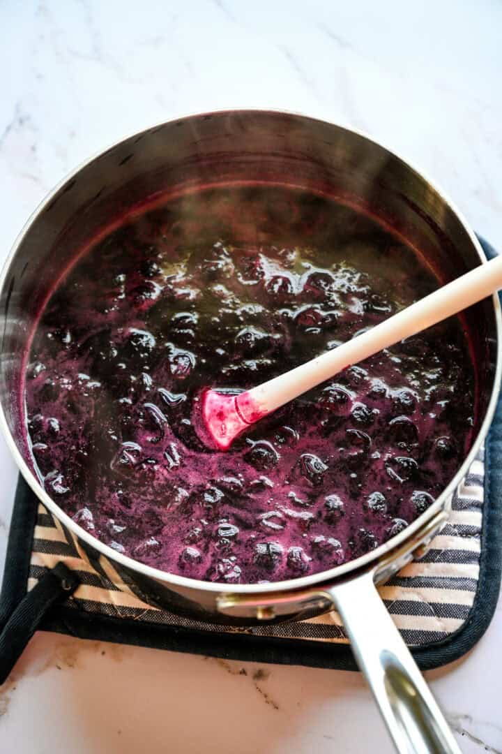 blueberries, sugar, honey and water in a saucepan after cooking.