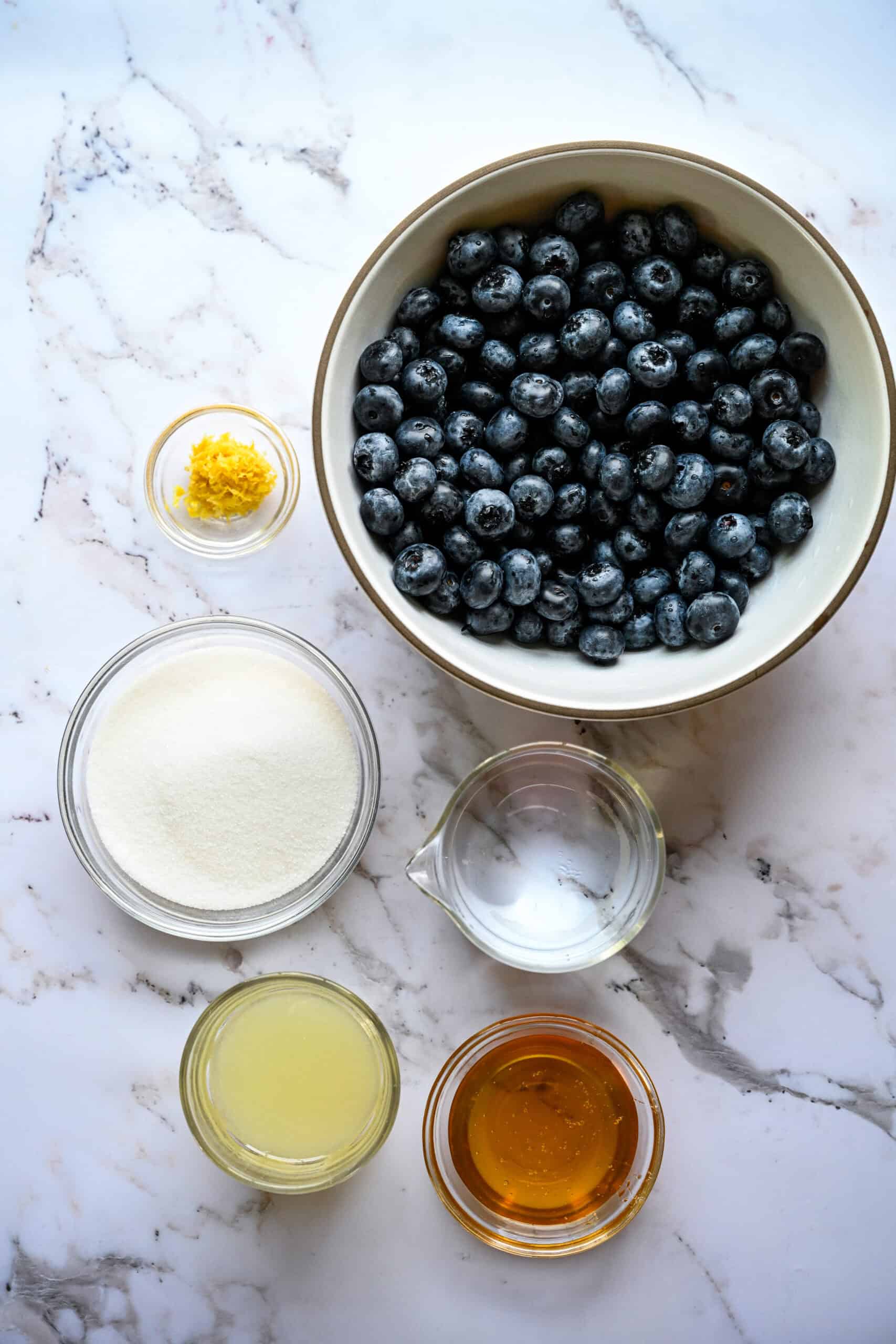 overhead view of ingredients for blueberry granita in small bowls.