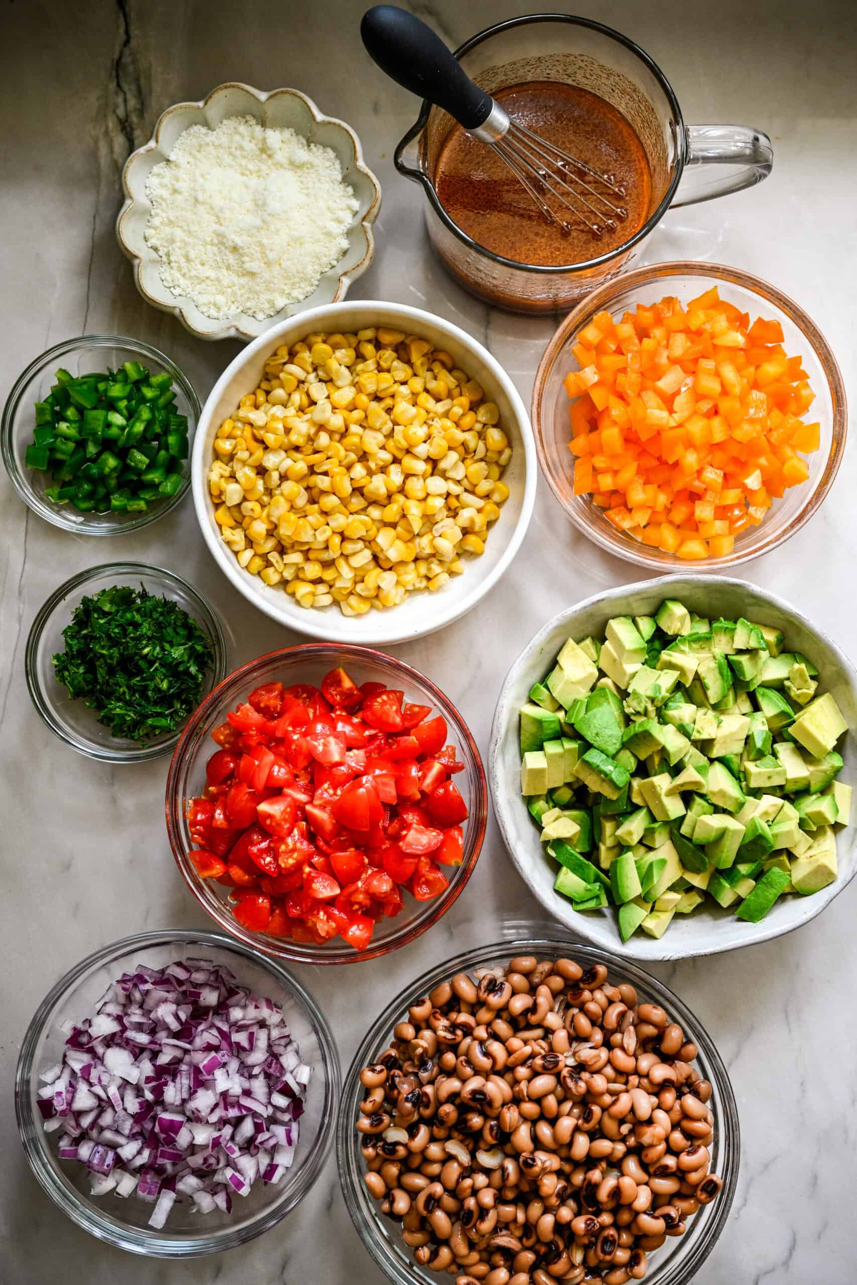 ingredients for cowboy caviar in separate glass bowls.
