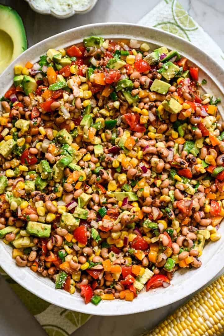 Overhead view of cowboy caviar salad in a big white salad bowl.