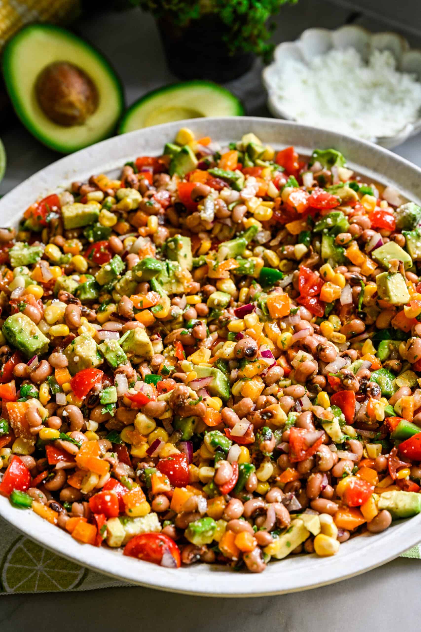 close up side view of cowboy caviar salad in a big white salad bowl.