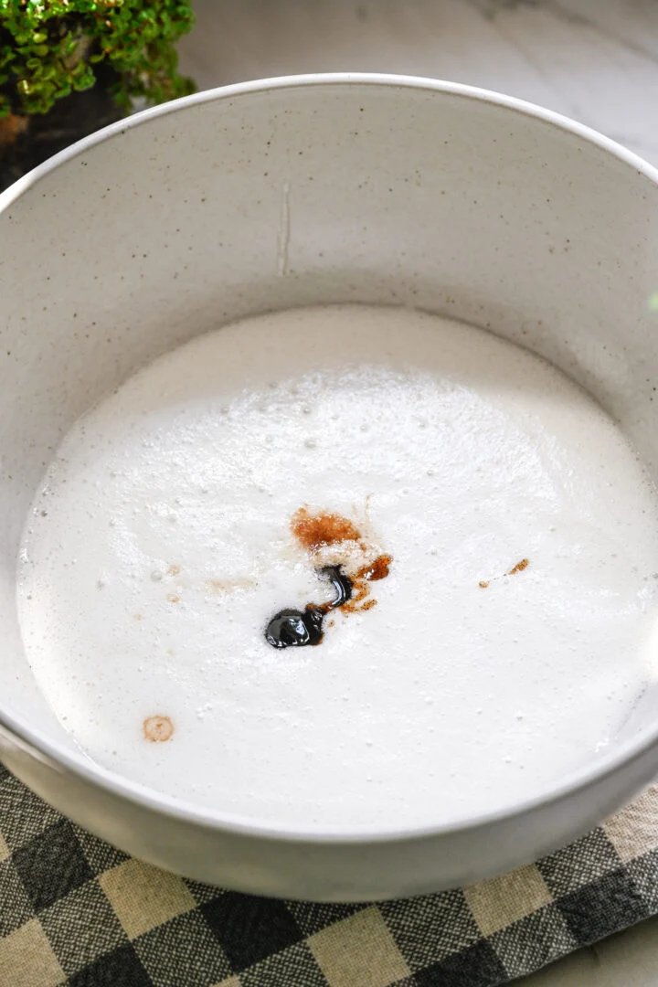 marshmallow fluff ingredients in a bowl with vanilla extracts added.