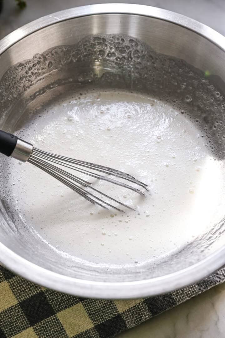 egg white, sugar and cream of tartar whisked into a foamy mixture over a double boiler.