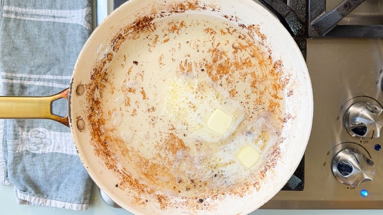 Butter and bacon fat in skillet on stovetop